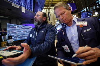 U.S. traders monitor market movements during thin year-end trading