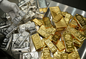 Gold and silver bars with market charts showing price increase